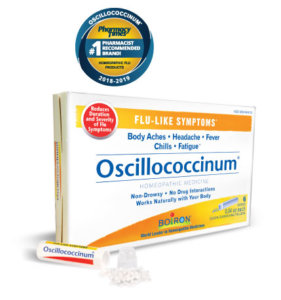 Oscillococcinum box and tube with pellets spilled out. Pharmacy Times #1 Homeopathic Flu Medicine.